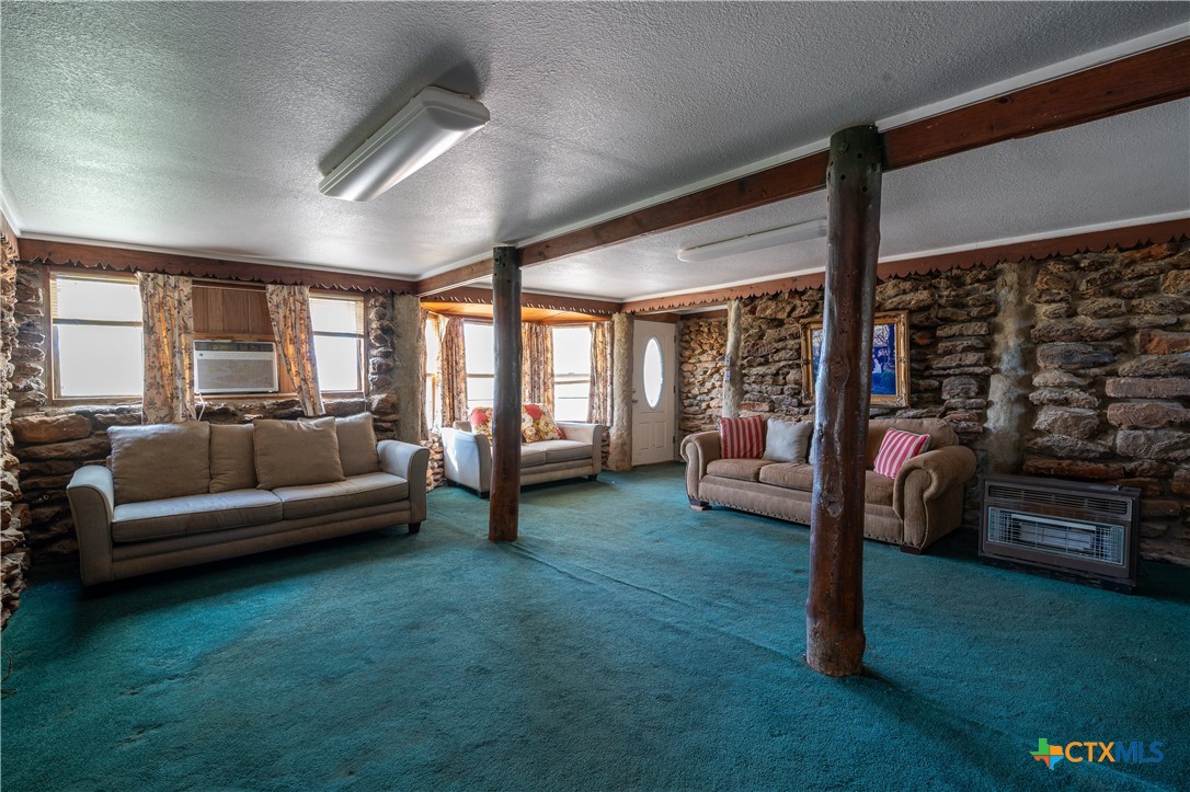 3779 Mule Creek Road Harwood, TX 78632 - Photo 10 of 40 a living room with furniture and a floor to ceiling window