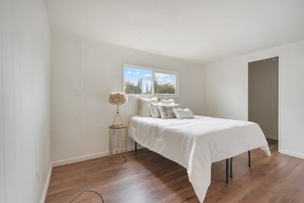 a bed room with a bed and a window