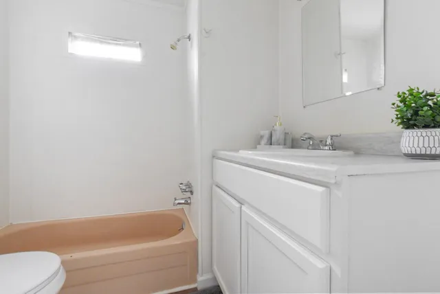 a bathroom with a sink toilet and bathtub