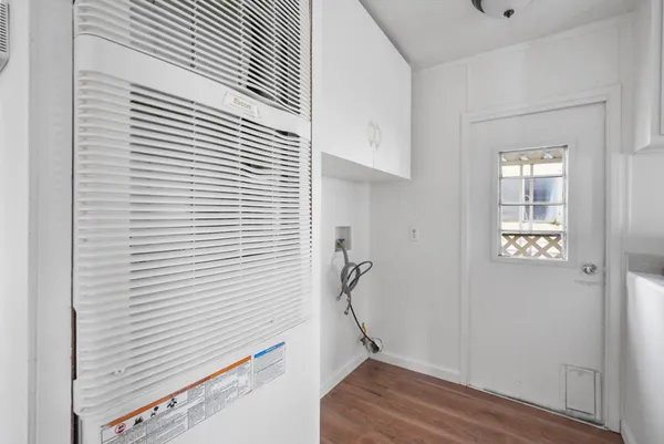 a view of an entryway with wooden floor
