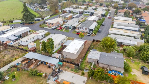 an aerial view of a house with a yard
