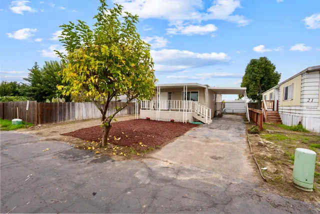 a backyard of a house with table and chairs