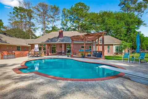 swimming pool view with a seating space and a garden view