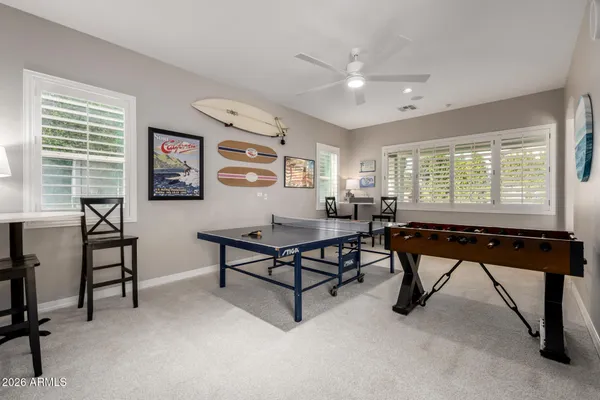 a dining room with wooden floor a chandelier a wooden table and chairs