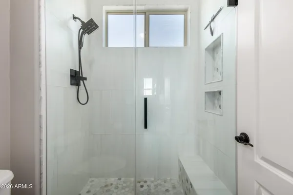 a view of a swimming pool with a table and chairs under an umbrella