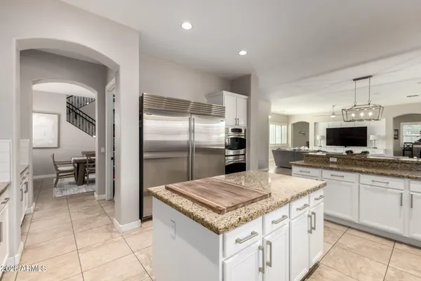 a kitchen with stainless steel appliances granite countertop a refrigerator and a sink