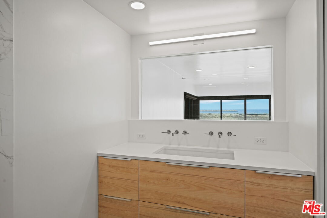 6 Voyage Street, Unit 108 Marina del Rey, CA 90292 - Photo 11 of 27 a bathroom with a sink and a mirror