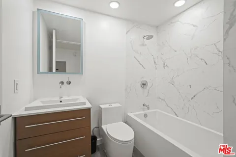 a bathroom with a sink a toilet and a bathtub