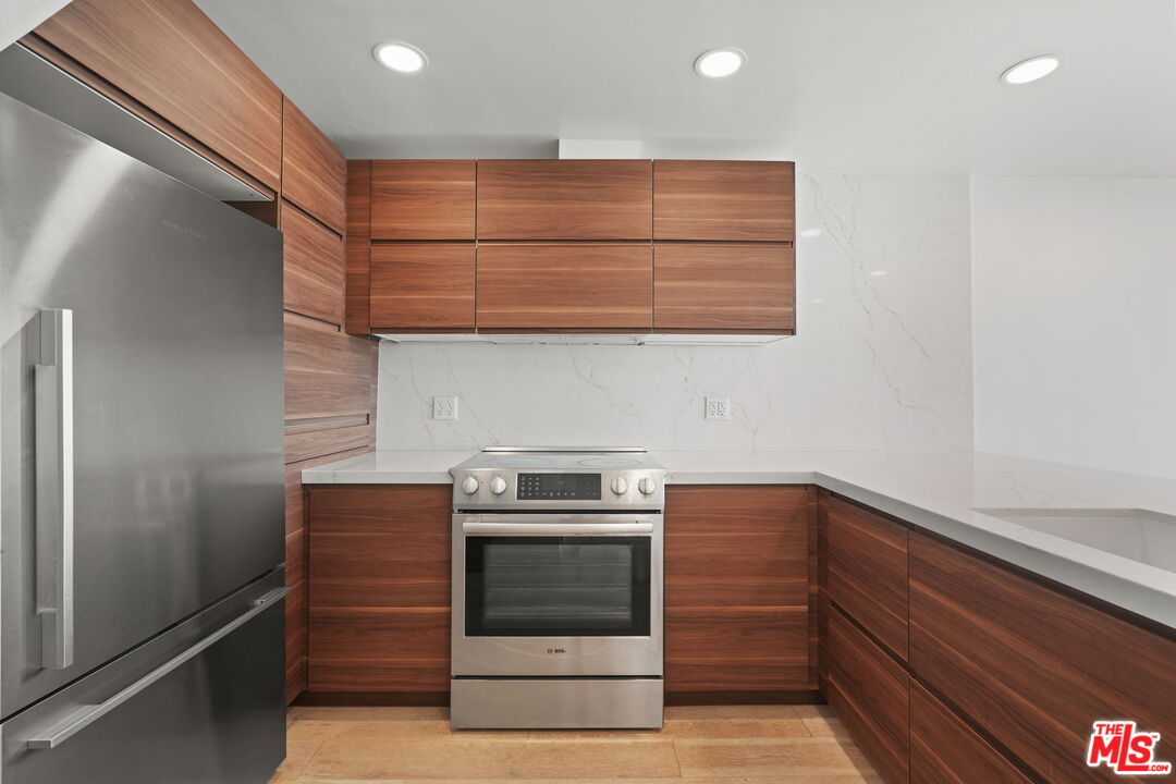 6 Voyage Street, Unit 108 Marina del Rey, CA 90292 - Photo 5 of 27 a kitchen with a stove and a cabinet