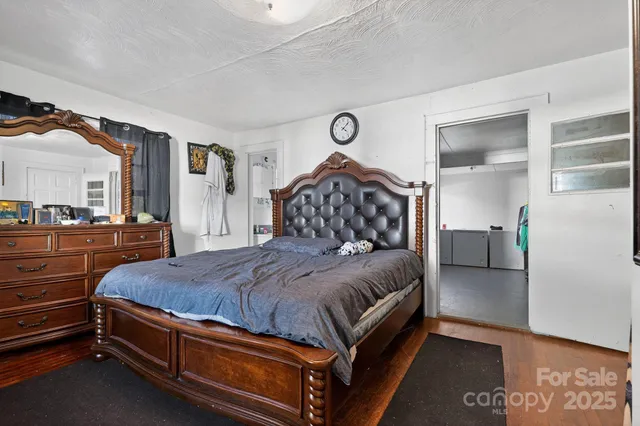 a spacious bedroom with a bed and a dresser