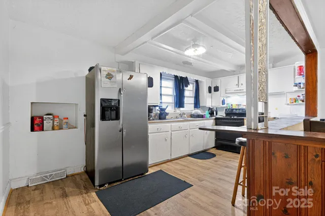a kitchen with stainless steel appliances a refrigerator sink and cabinets