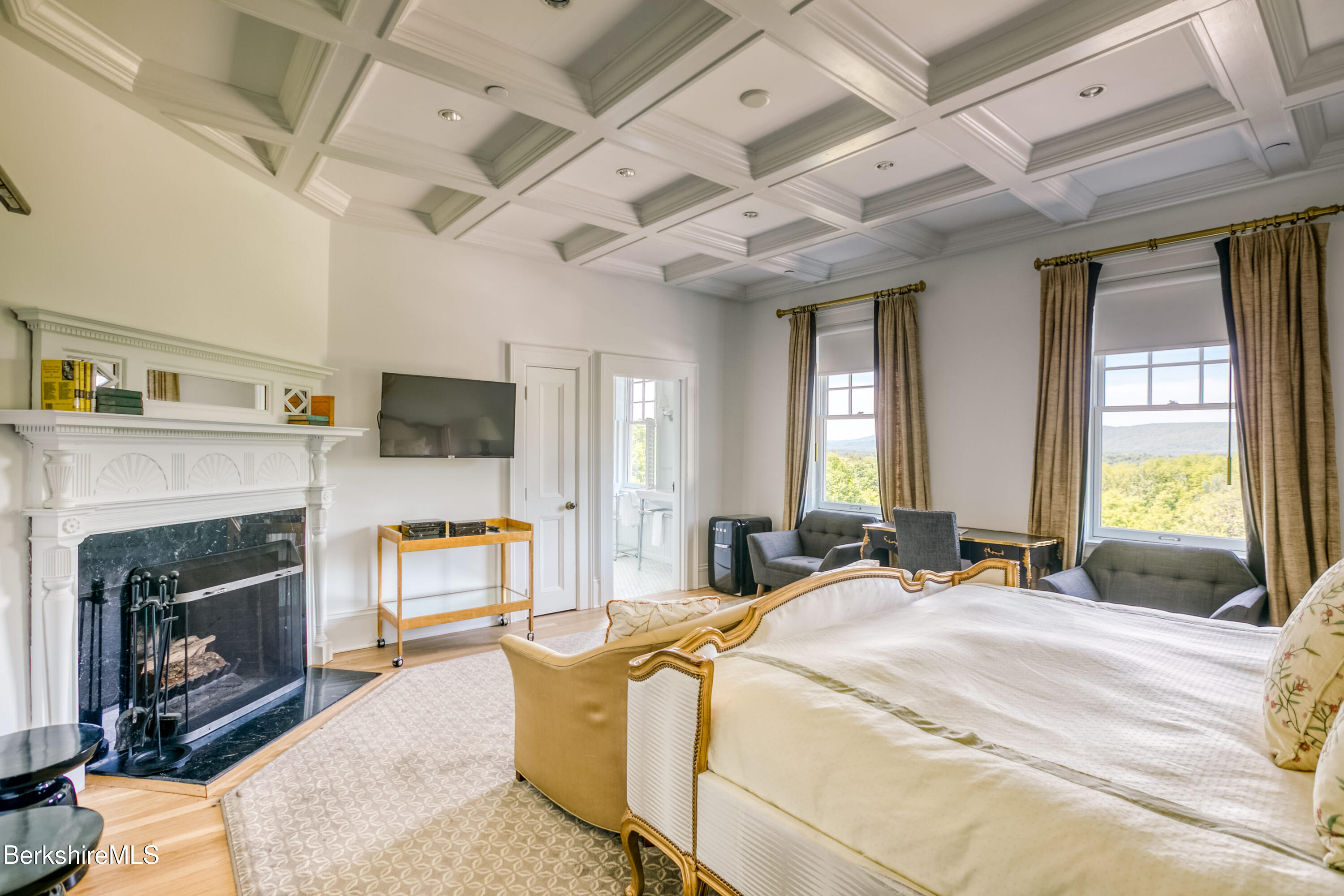 2 Kemble Street Lenox, MA 01240 - Photo 11 of 41 a spacious bedroom with a bed and a fireplace