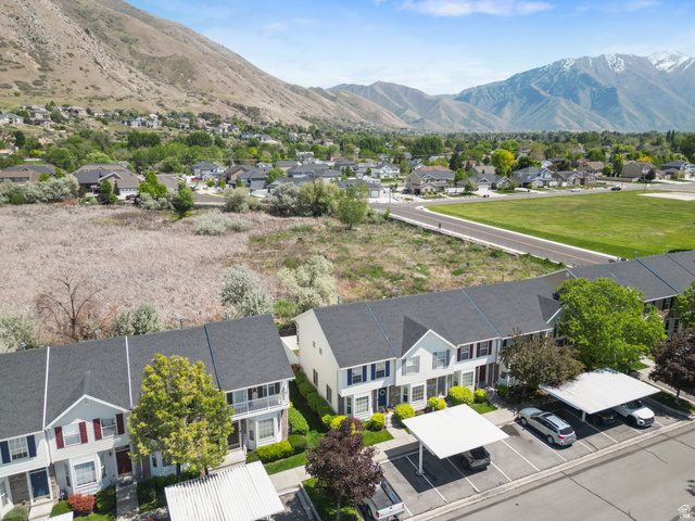 732 North 200 E Street Springville, UT 84663 - Photo 31 of 36 Townhome community featuring mountain scenery, paved parking areas with covered carports, and mature landscaping