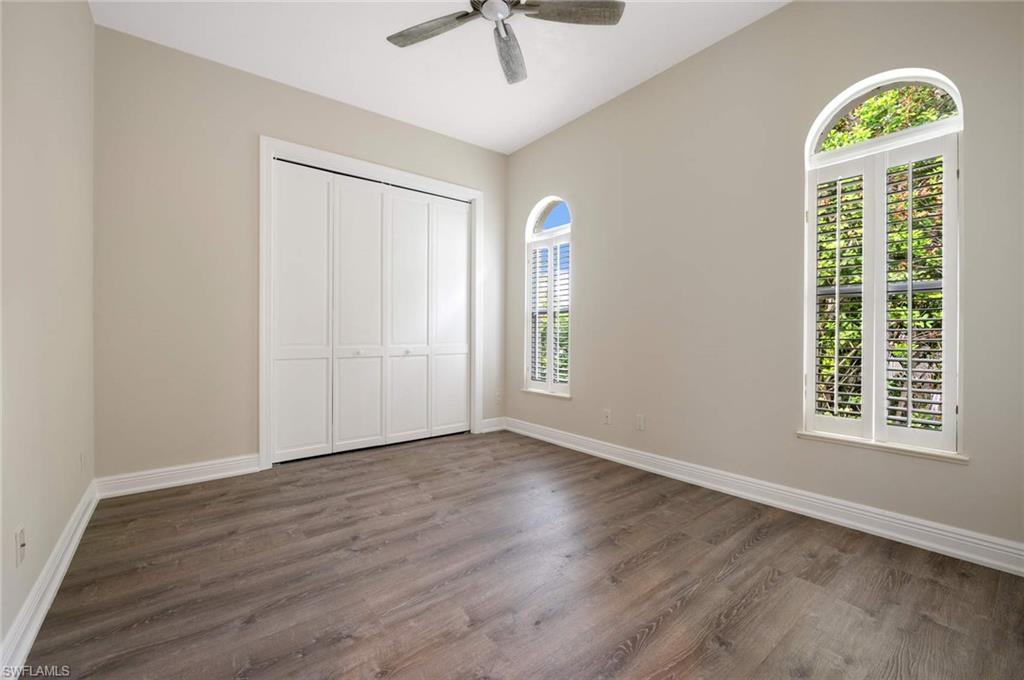 2115 Imperial Golf Course Boulevard Naples, FL 34110 - Photo 16 of 31 wooden floor in an empty room with a window