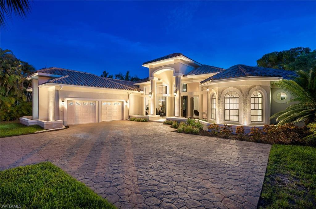 2115 Imperial Golf Course Boulevard Naples, FL 34110 - Photo 2 of 31 a view of a house with a yard