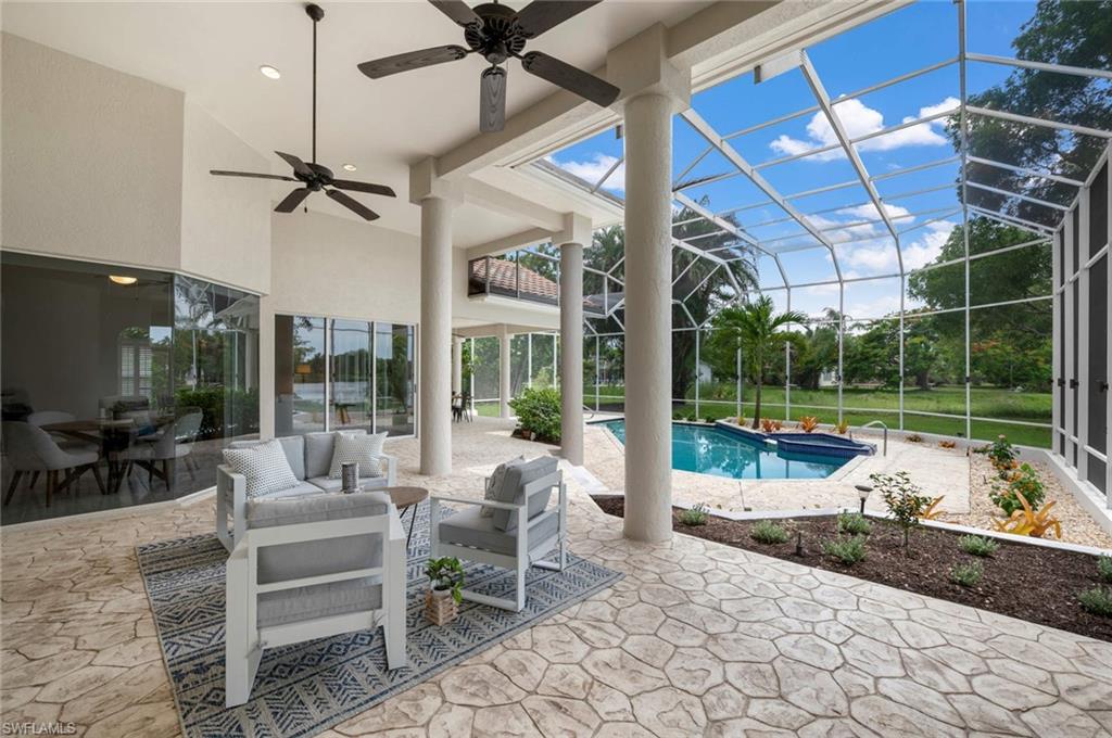 2115 Imperial Golf Course Boulevard Naples, FL 34110 - Photo 21 of 31 a living room with patio furniture and a floor to ceiling window