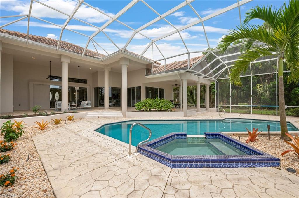 2115 Imperial Golf Course Boulevard Naples, FL 34110 - Photo 23 of 31 a view of a patio with a table and chairs
