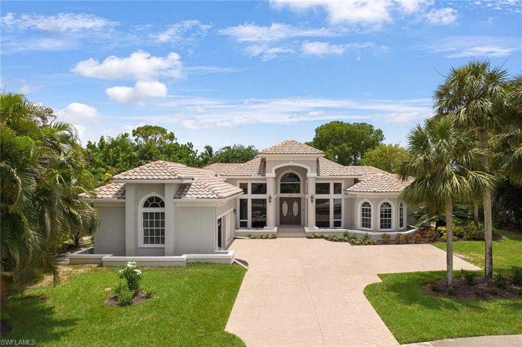 2115 Imperial Golf Course Boulevard Naples, FL 34110 - Photo 31 of 31 a front view of a house with a yard