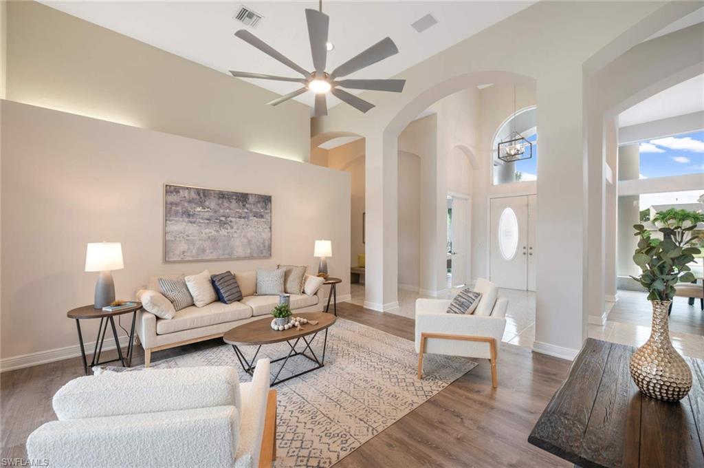 2115 Imperial Golf Course Boulevard Naples, FL 34110 - Photo 6 of 31 a living room with furniture and a wooden floor