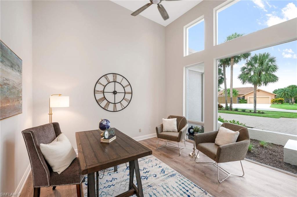 2115 Imperial Golf Course Boulevard Naples, FL 34110 - Photo 8 of 31 a living room with furniture a table and a large window