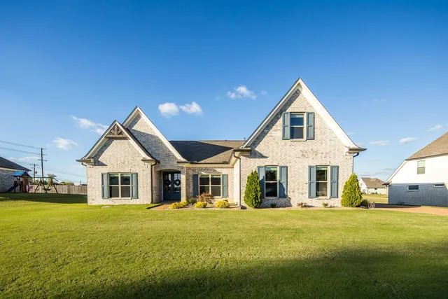 a front of a house with a garden and porch