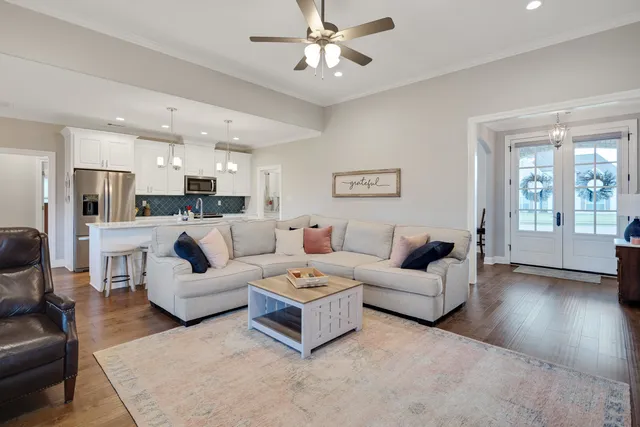 a living room with furniture and a chandelier