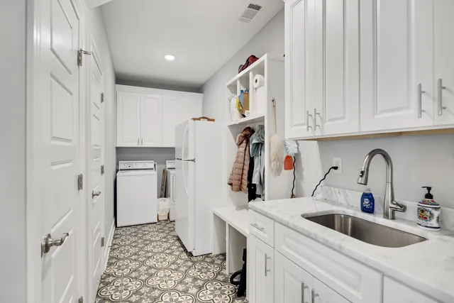 a kitchen with refrigerator and cabinets