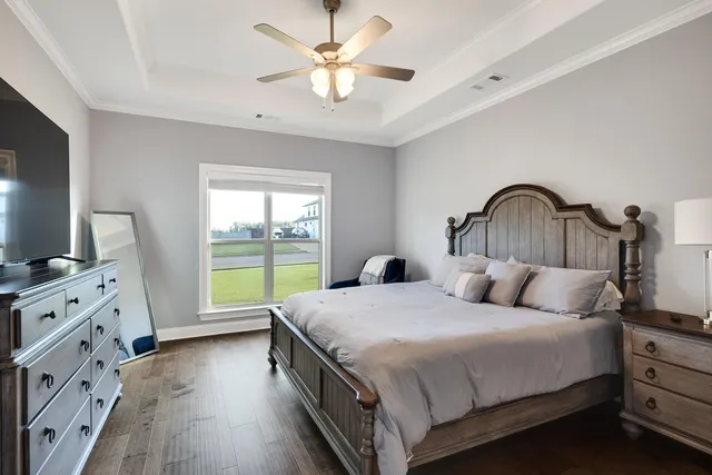 a bedroom with a bed and a flat screen tv