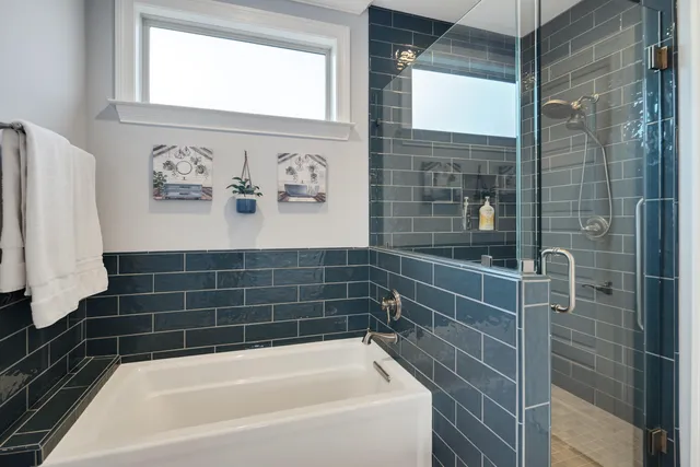 a bathroom with a bathtub and shower