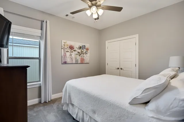 a bedroom with a large bed and a chandelier
