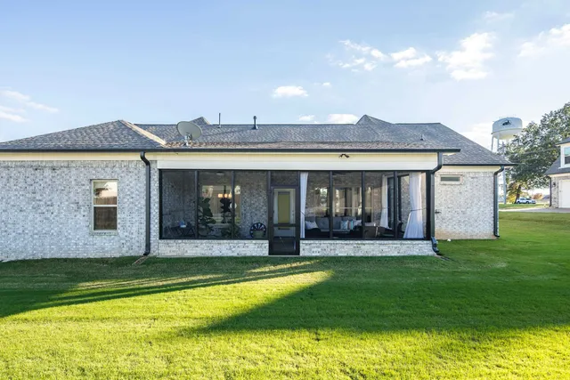 a view of a house with swimming pool and a yard