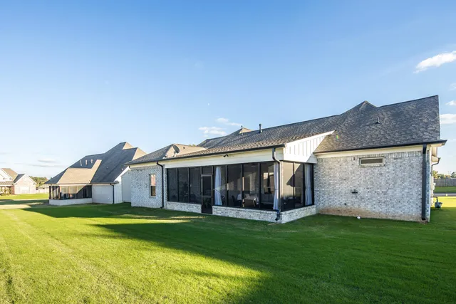 a view of house with garden and patio