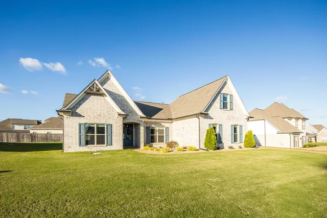a front view of a house with a garden