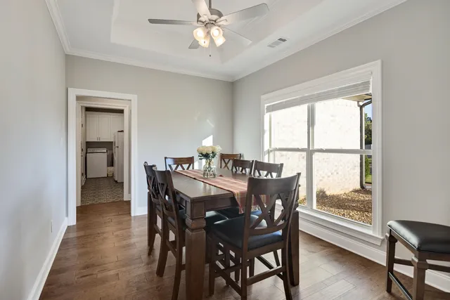a dining room with furniture a rug and a large window