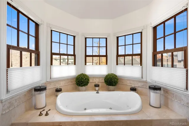 a bathroom with a tub sink shower and mirror