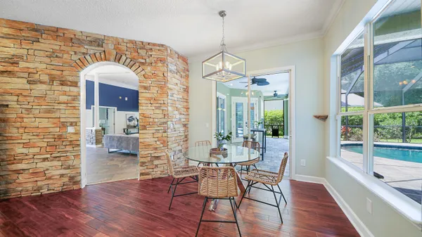 a view of a dining room with furniture window and wooden floor