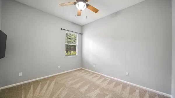 a bedroom with a bed and a chair