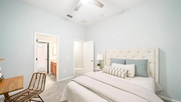 an empty room with a chandelier fan and a ceiling fan