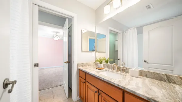 a view of entryway and kitchen with wooden floor