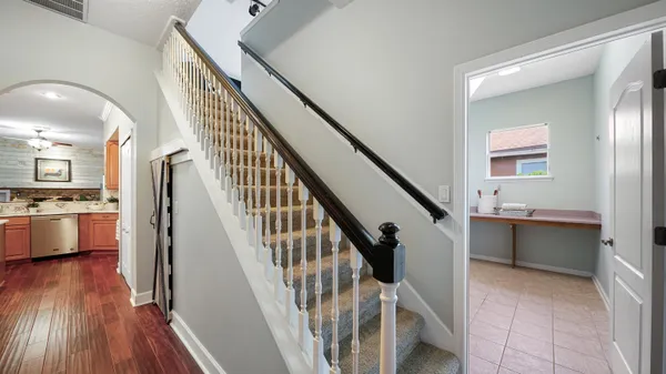 a view of a porch with chairs and backyard