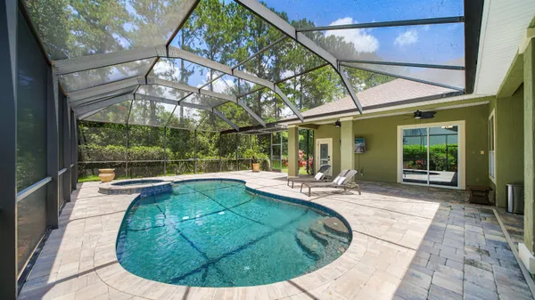 a swimming pool with outdoor seating and yard