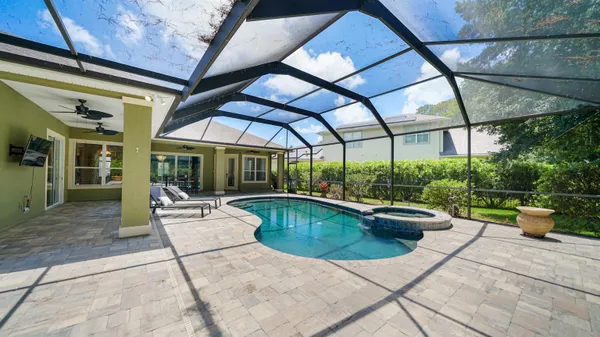 a view of a yard in front of a house with large trees