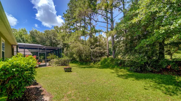 an aerial view of house with yard and mountain view in back