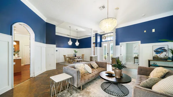 a living room with furniture and a chandelier