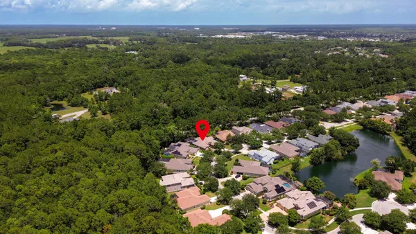 an aerial view of a house with a garden and swimming pool