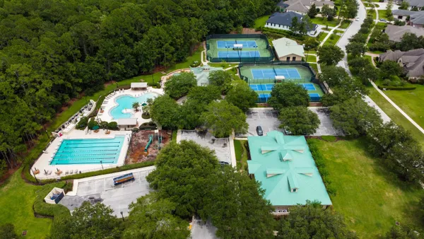 a front view of a house with a garden and yard