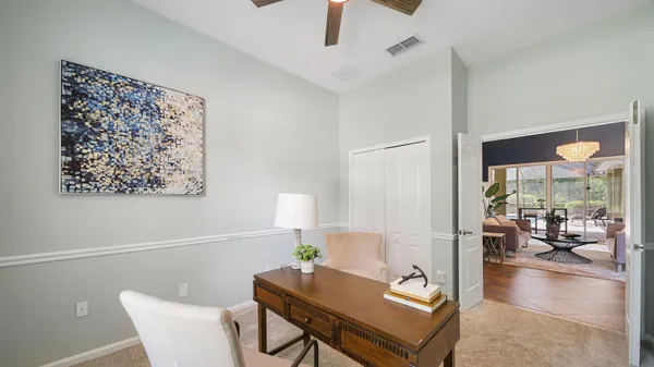 a view of a workspace with furniture and a window