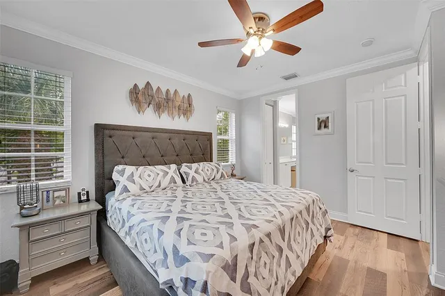a bedroom with a large bed and a chandelier