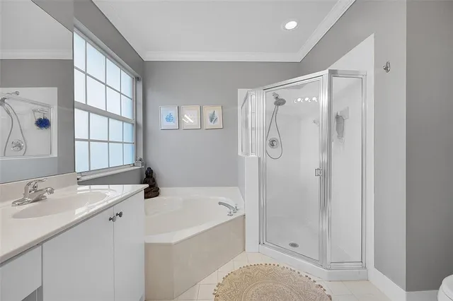 a bathroom with a tub sink and mirror