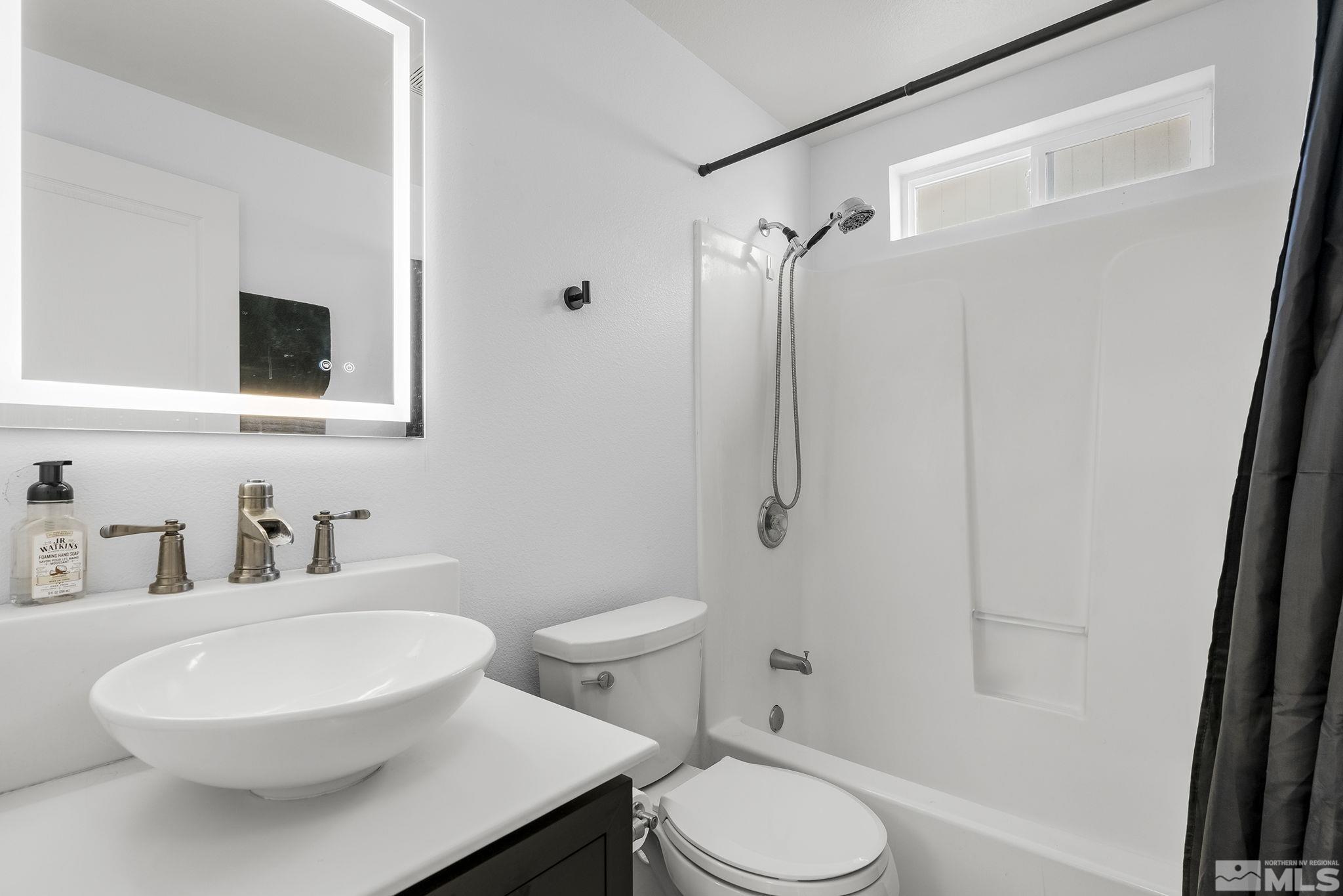 940 Atrium Road Fernley, NV 89408 - Photo 12 of 20 a white toilet sitting next to a bathroom sink